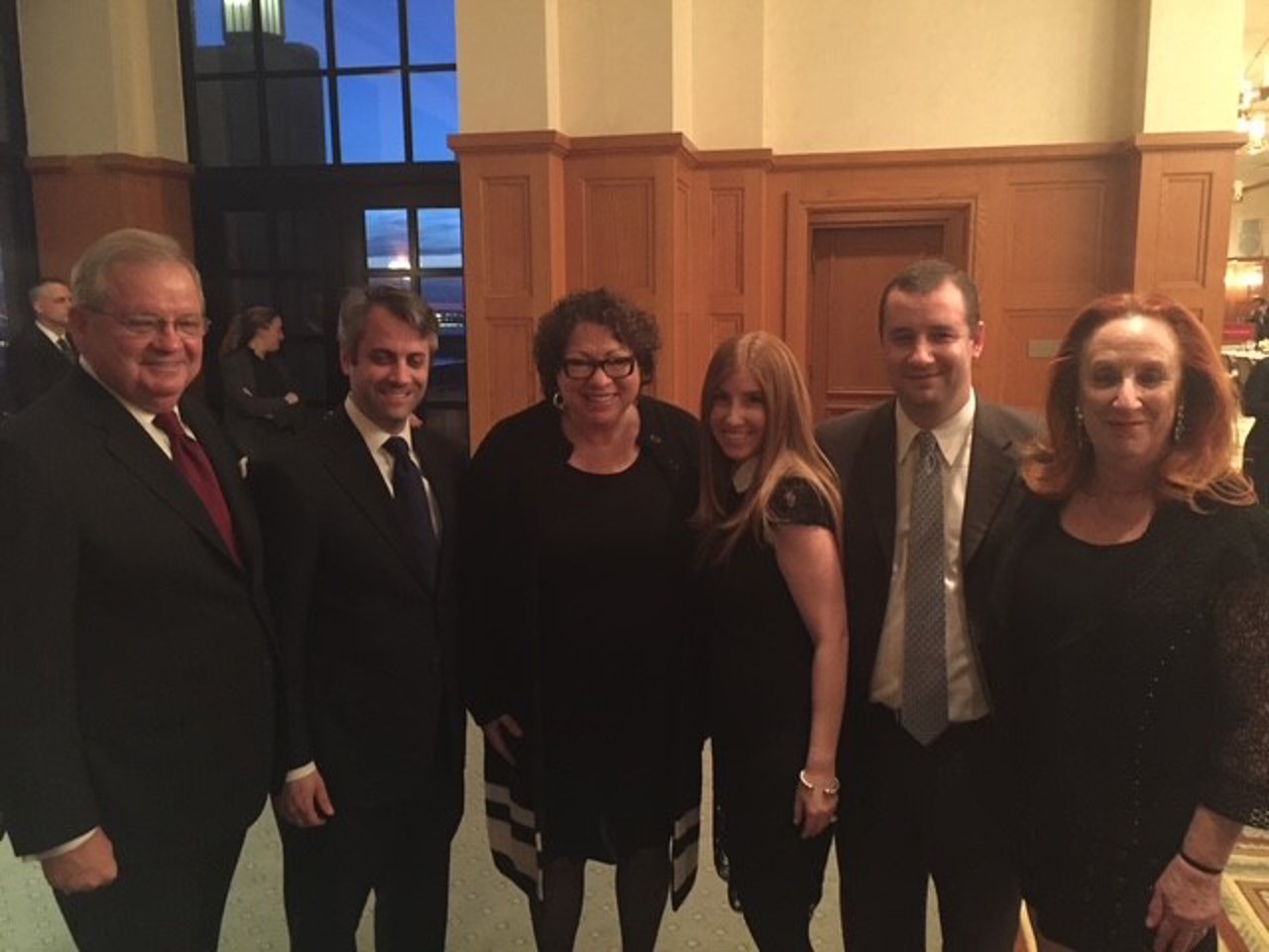 Photo of Nick, Marla, and friends all stood smiling and looking into camera.