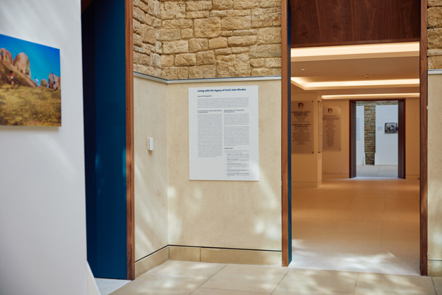 A Plaque On The Wall Explains The Living With The Legacy Of Cecil John Rhodes Photography Exhibition