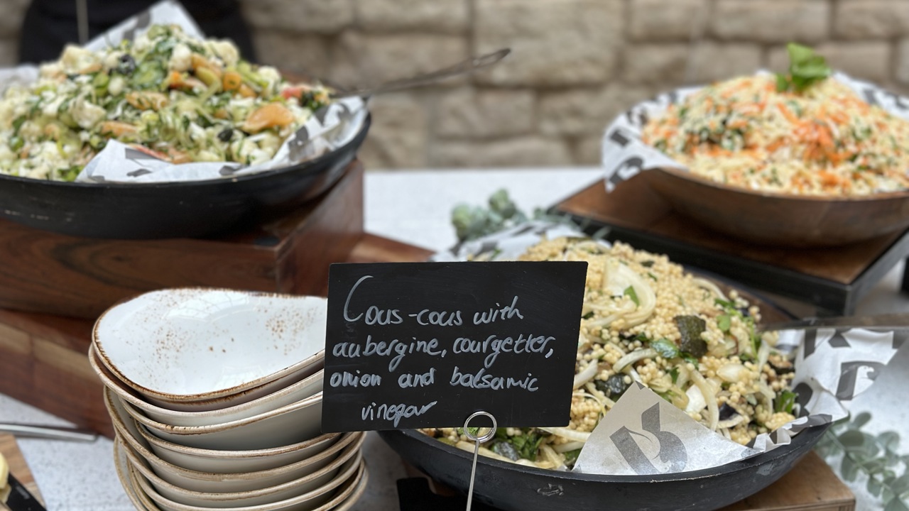 Close up of salads set out as part of a bowl food lunch.